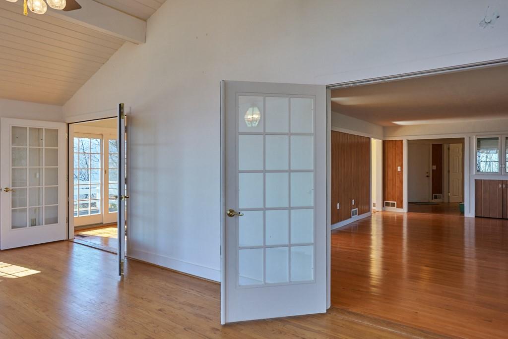 2871 Hogback Mountain Road Tryon, NC 28782 - Photo 19 of 33 wooden floor in an empty room with a window