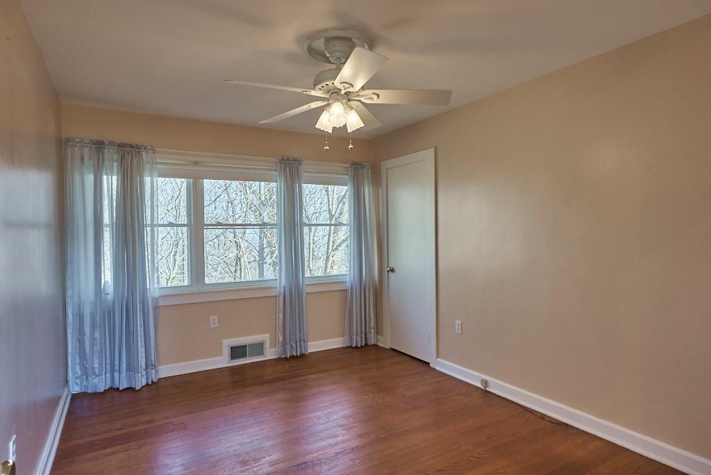 2871 Hogback Mountain Road Tryon, NC 28782 - Photo 26 of 33 an empty room with wooden floor fan and windows
