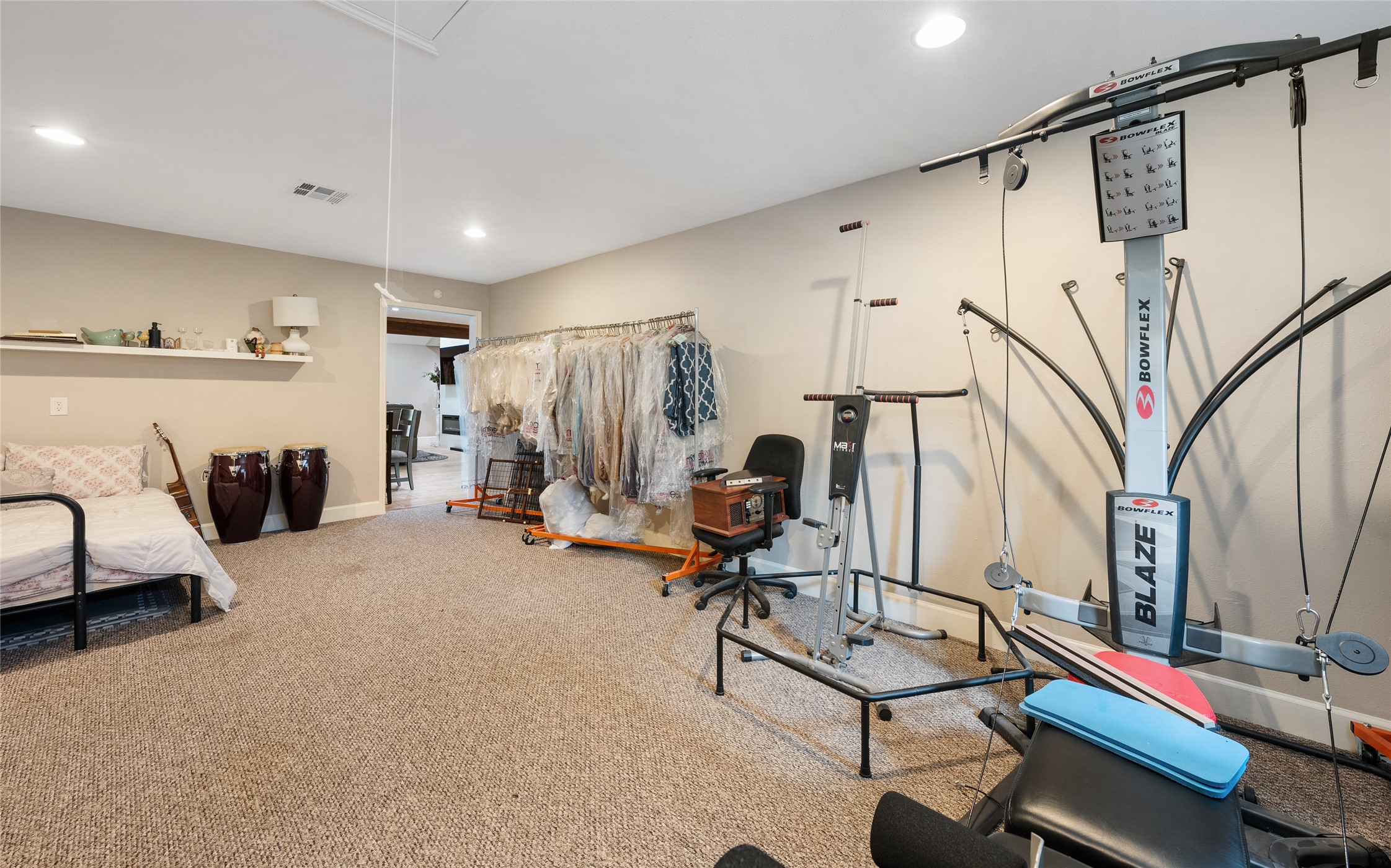 301 Oak Ridge Road Georgetown, TX 78628 - Photo 16 of 34 Carpeted room featuring recessed lighting, a floating wall shelf, and a doorway opening to another interior space