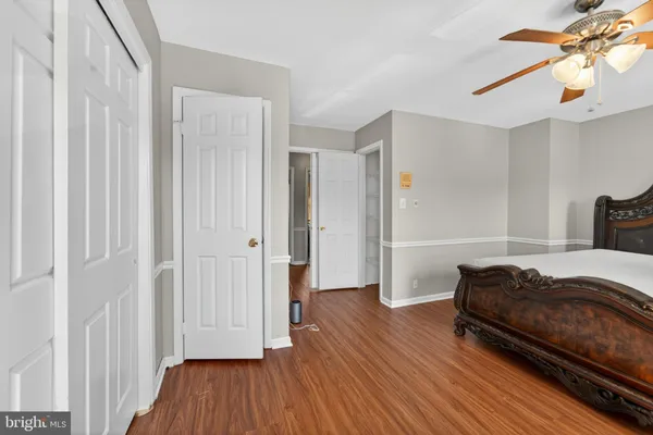 a bedroom with a bed and ceiling fan