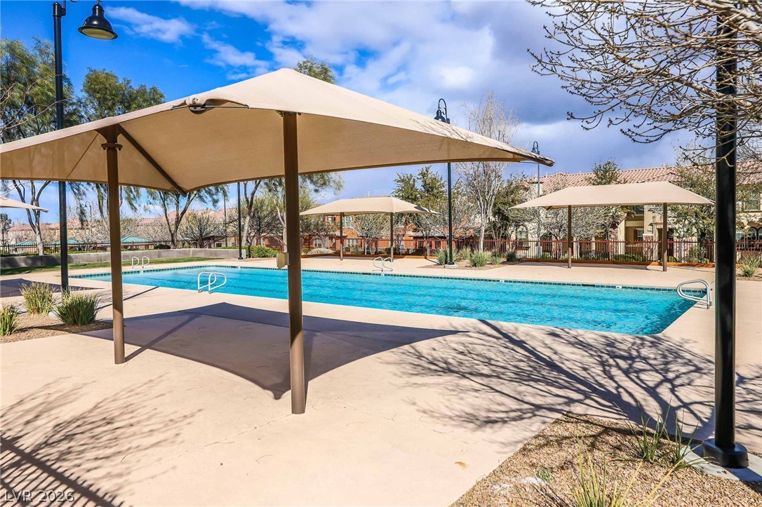 3175 Via Seranova Henderson, NV 89044 - Photo 42 of 45 An inviting outdoor pool with ample shade awaits, offering a refreshing retreat on sunny days.