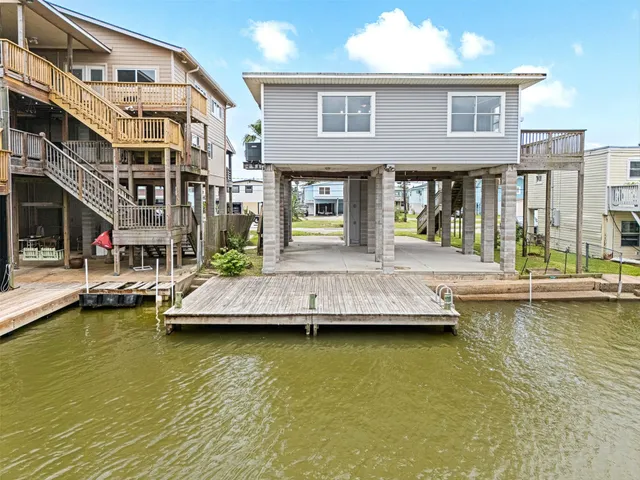 a kitchen with cabinets stainless steel appliances and a window