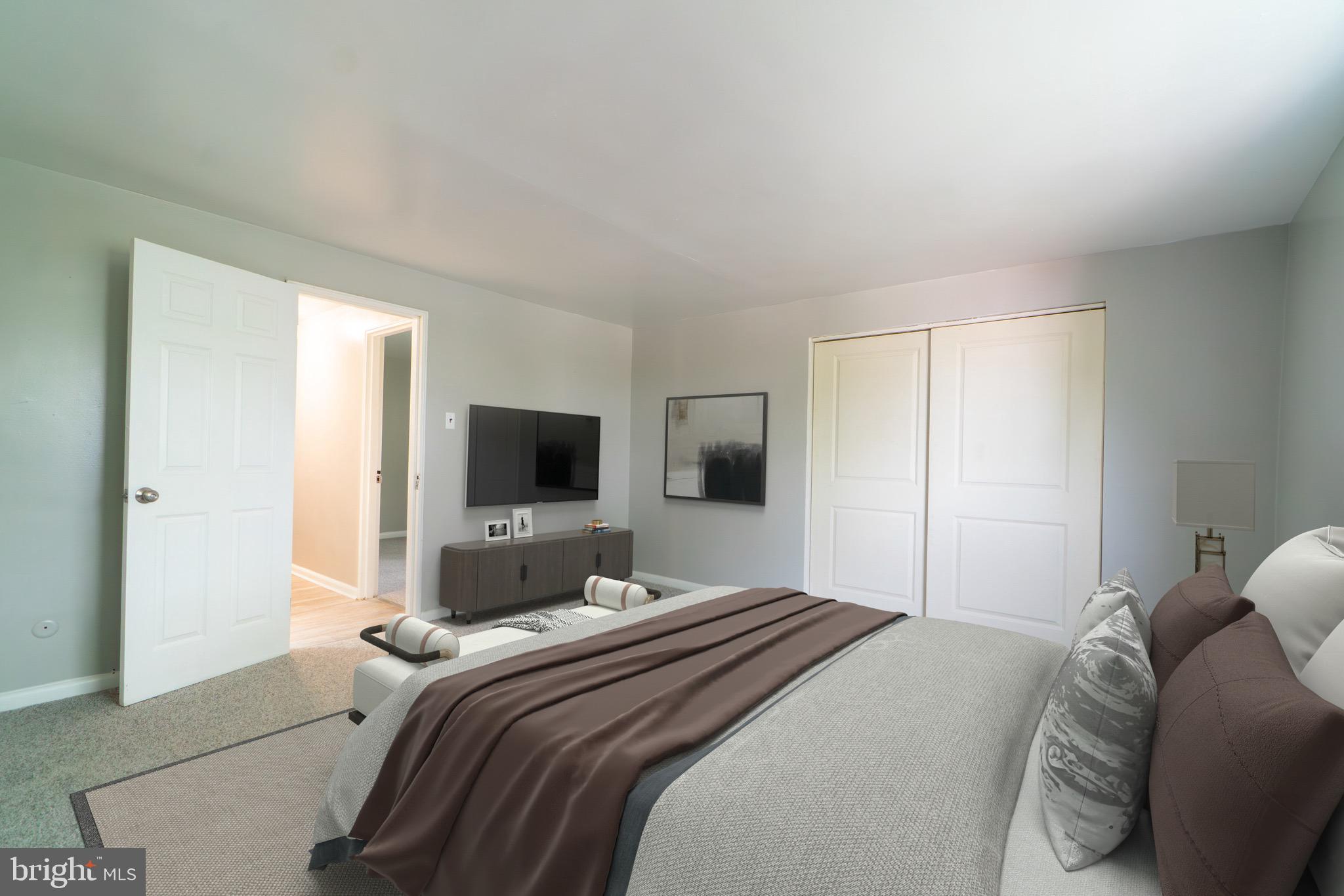 4616 Leiper Street, Unit A1 Philadelphia, PA 19124 - Photo 6 of 12 a bedroom with a bed and a flat screen tv