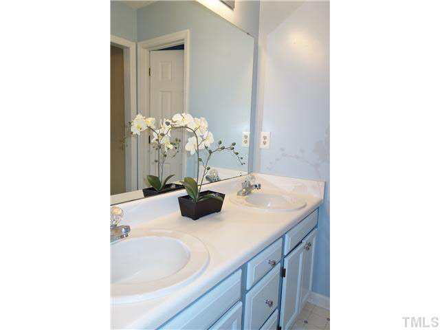 4420 Labrador Drive Raleigh, NC 27616 - Photo 11 of 21 a bathroom with a sink tub and a mirror