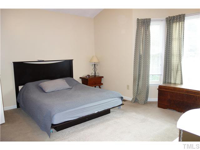 4420 Labrador Drive Raleigh, NC 27616 - Photo 8 of 21 a bed sitting in a bedroom next to a window