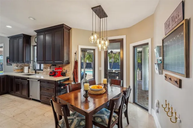 a kitchen that has a table and chairs in it
