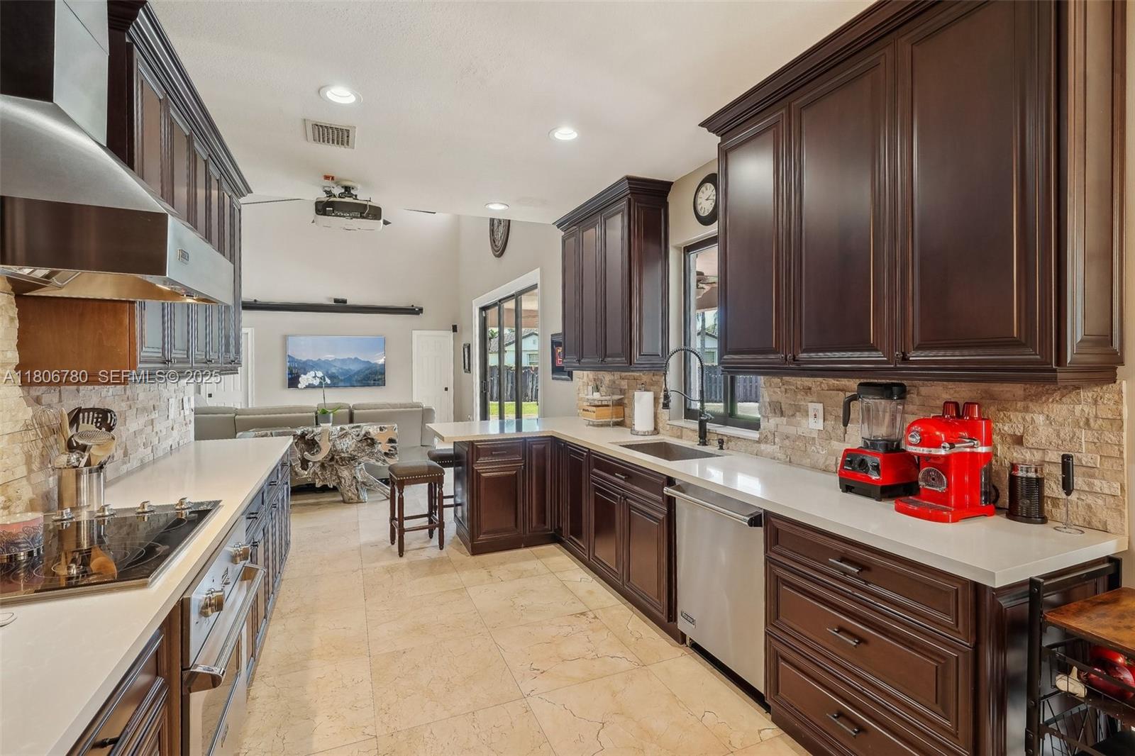 11898 Southwest 74th Terrace Miami, FL 33183 - Photo 18 of 68 a kitchen with granite countertop lots of counter top space a sink stainless steel appliances and cabinets