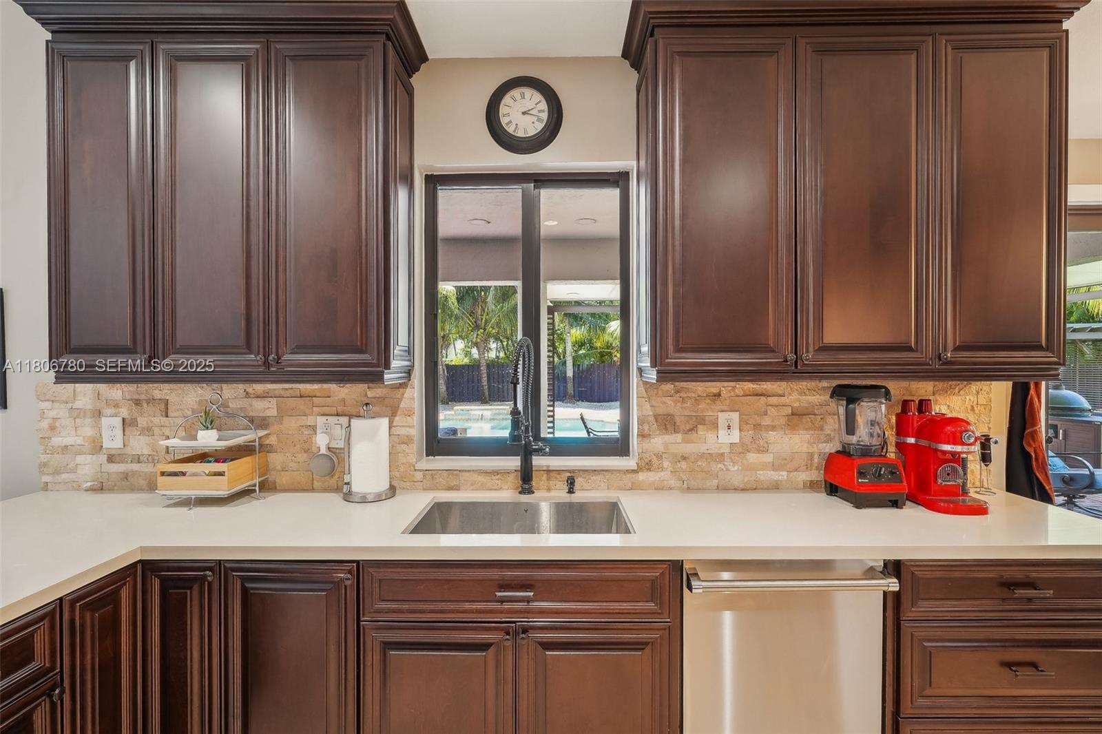 11898 Southwest 74th Terrace Miami, FL 33183 - Photo 21 of 68 a kitchen with stainless steel appliances granite countertop wooden cabinets a sink and a window