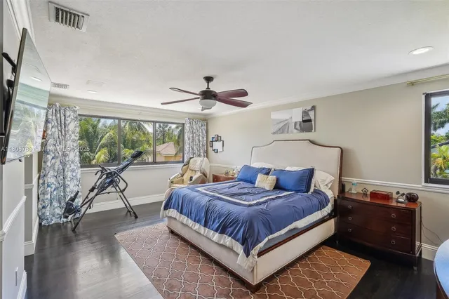 a bedroom with a large bed and a chandelier
