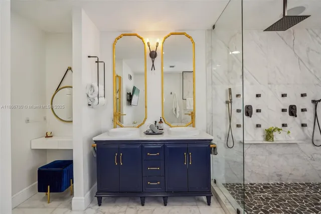 a spacious bathroom with a granite countertop sink a mirror and shower