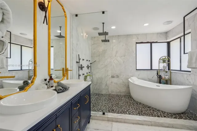 a bathroom with a double vanity sink a mirror and a bathtub