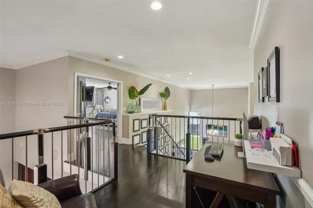 a view of a hallway with couches and dining table with wooden floor