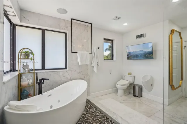 a bathroom with a toilet sink and mirror