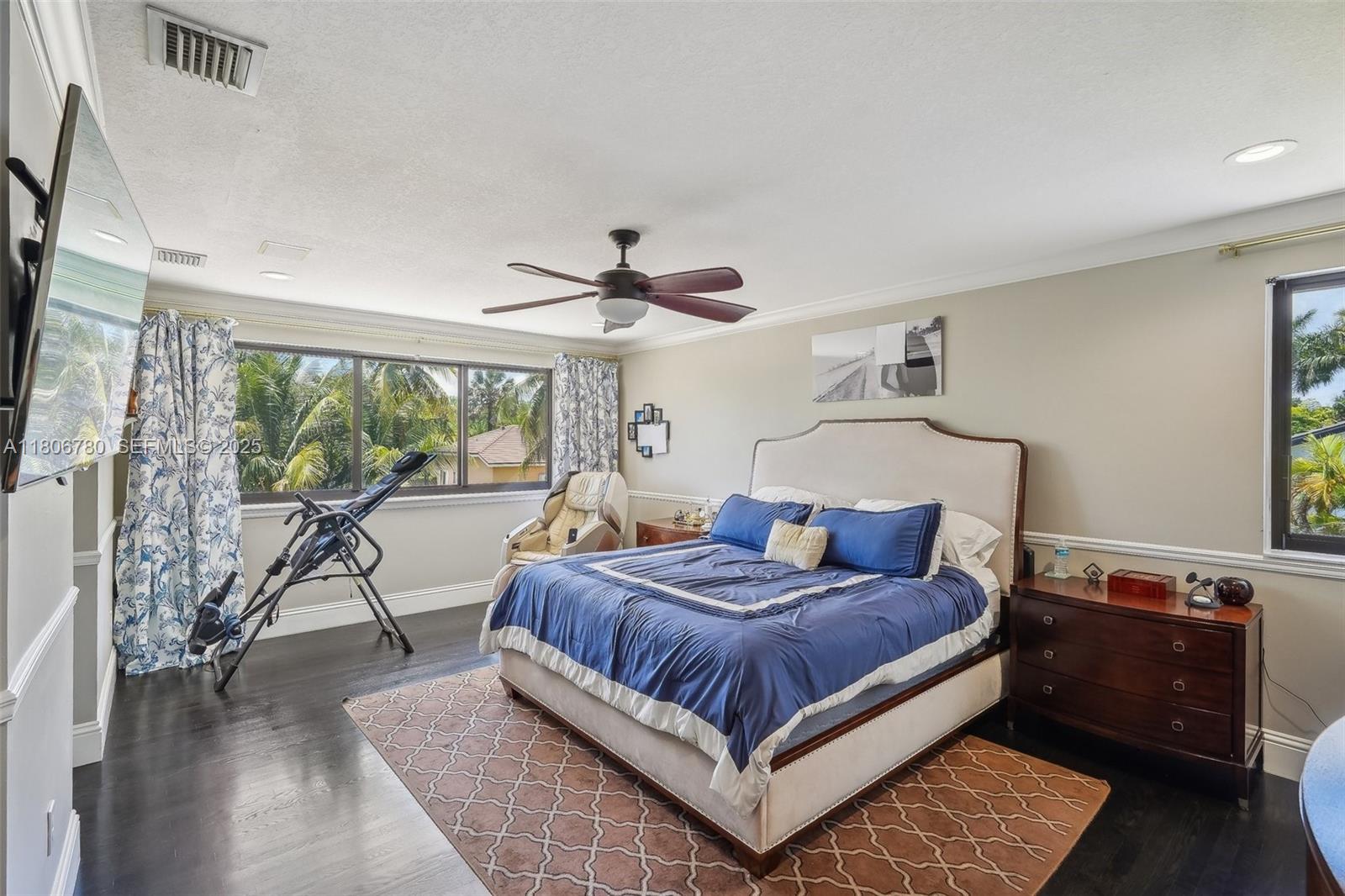 11898 Southwest 74th Terrace Miami, FL 33183 - Photo 30 of 68 a bedroom with a large bed and a chandelier