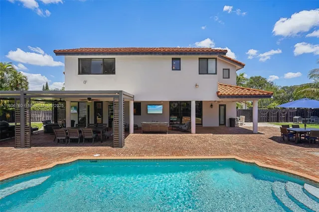 a view of a house with a yard and sitting area