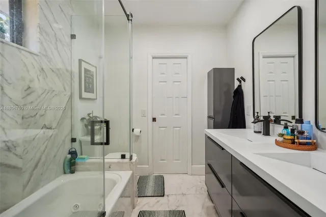 a bathroom with a tub sink and mirror