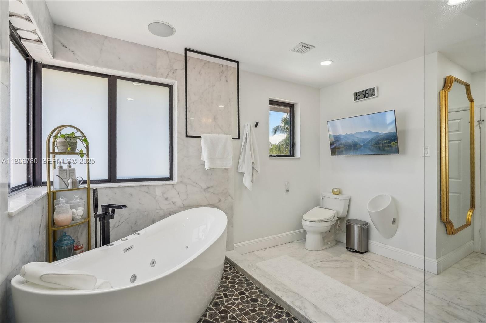 11898 Southwest 74th Terrace Miami, FL 33183 - Photo 38 of 68 a bathroom with a toilet sink and mirror