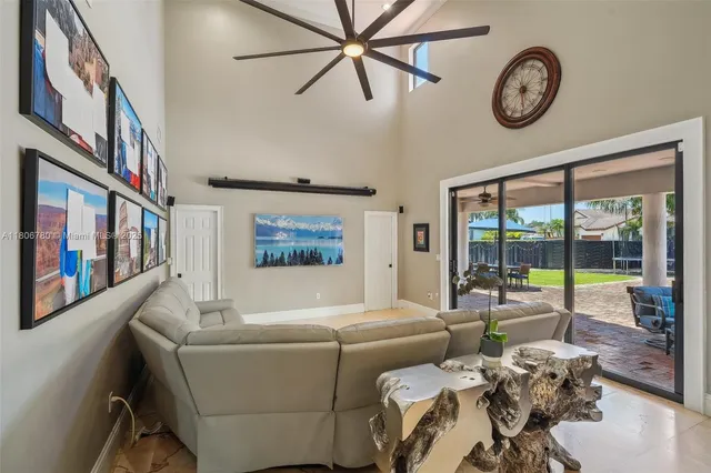 a living room with furniture a large window and a clock