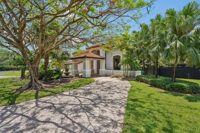 a view of a house with swimming pool and sitting area