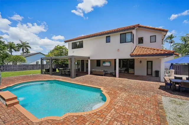 an aerial view of a house with a yard and potted plants