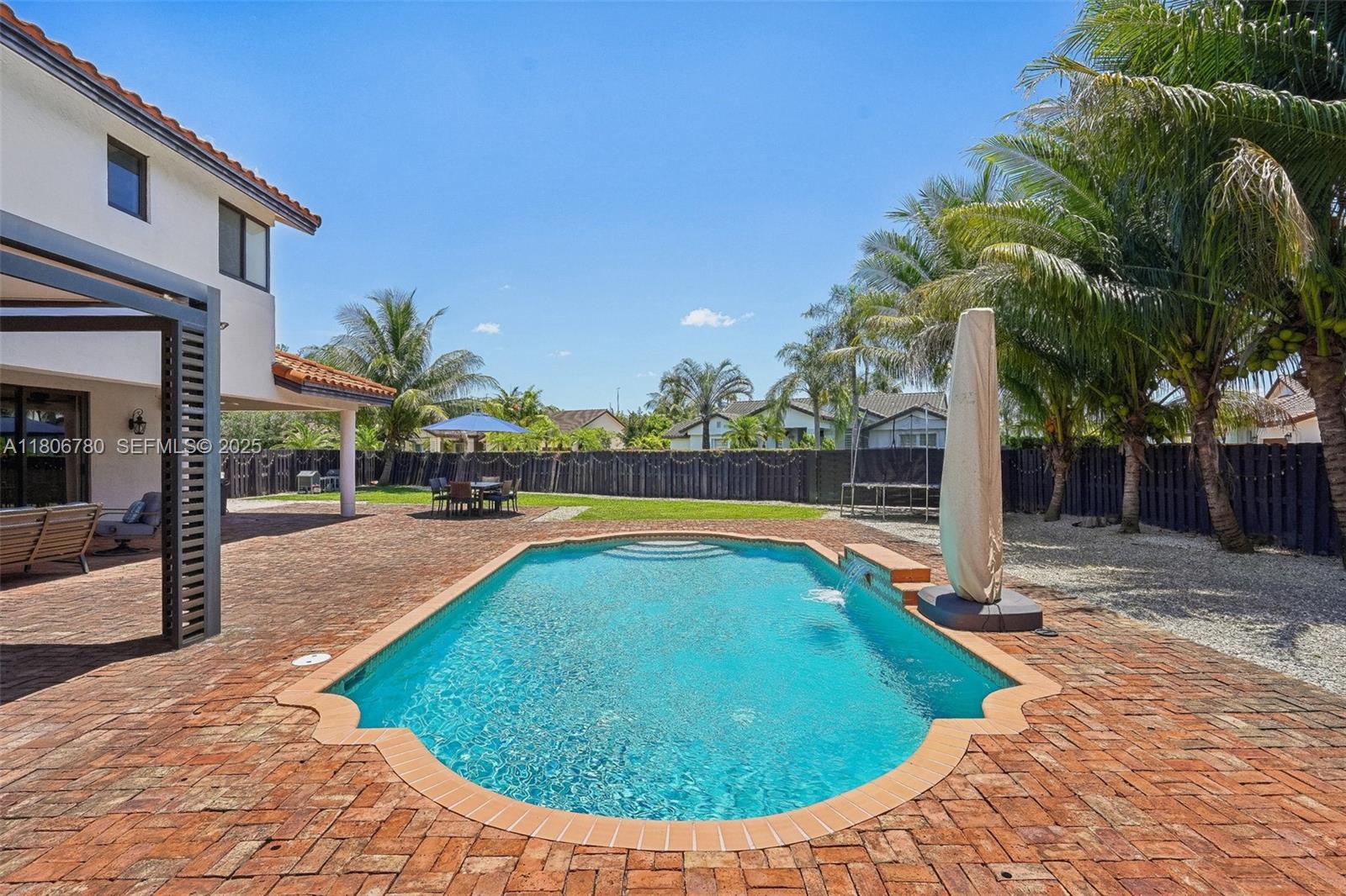 11898 Southwest 74th Terrace Miami, FL 33183 - Photo 58 of 68 a swimming pool with outdoor seating and yard