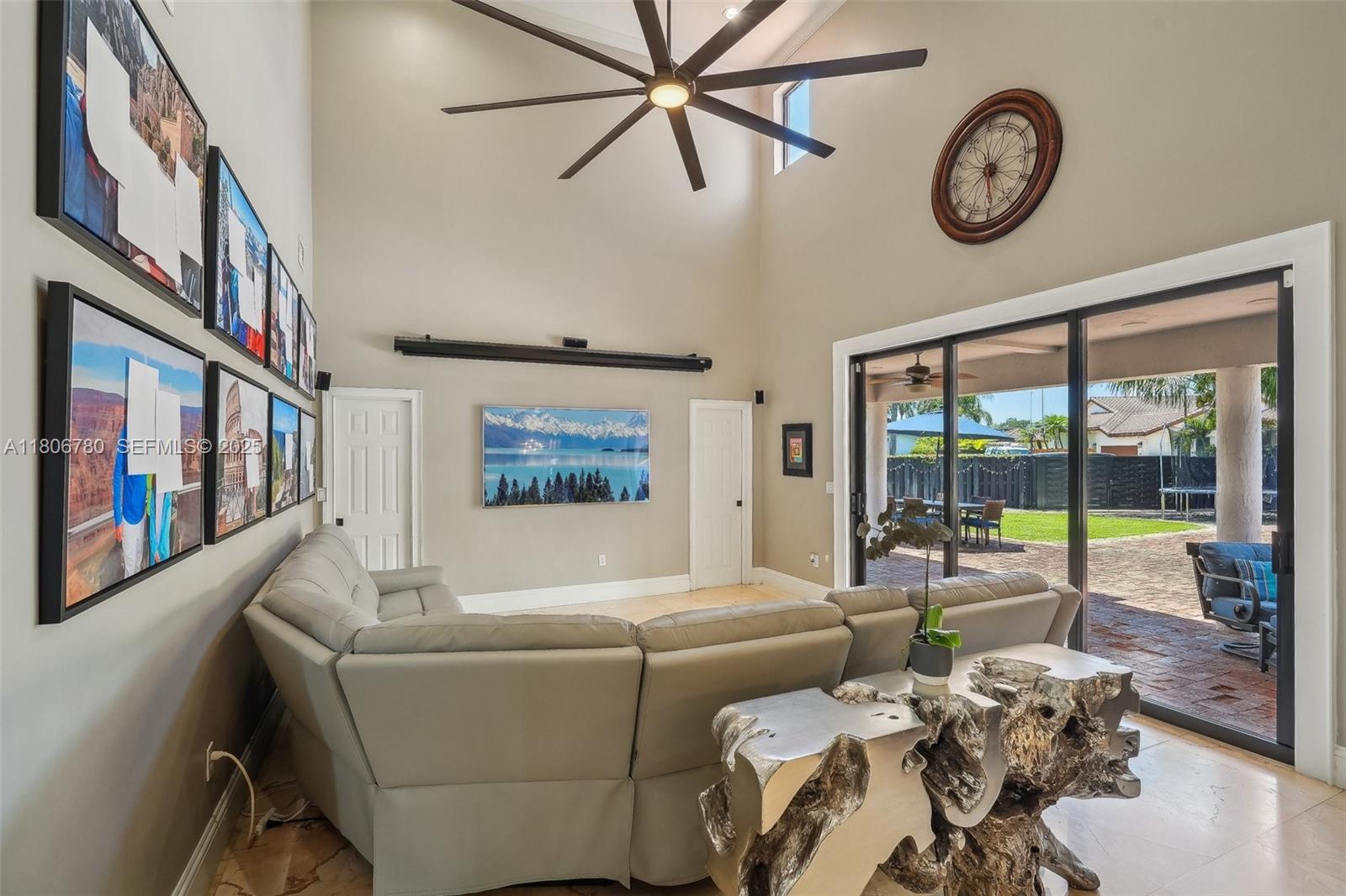 11898 Southwest 74th Terrace Miami, FL 33183 - Photo 6 of 68 a living room with furniture a large window and a clock
