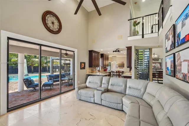 a living room with furniture a large window and a clock