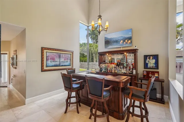 a dining room with furniture a chandelier and a rug