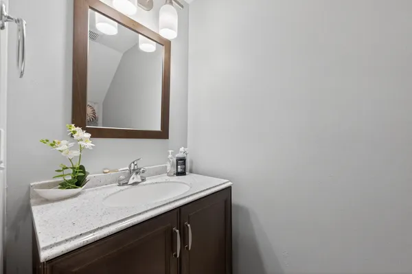 a bathroom with a sink vanity and a mirror