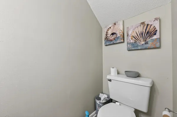 a white toilet sitting next to a bathroom sink