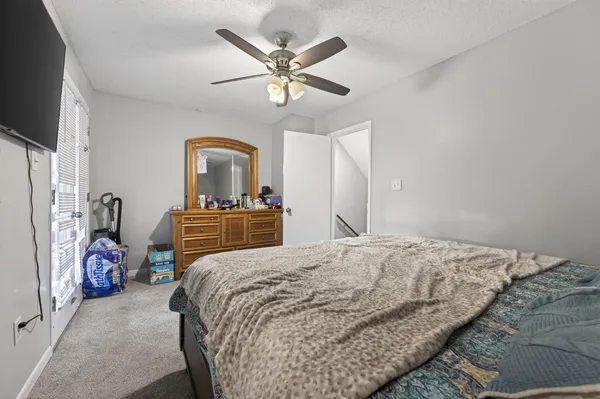 a bedroom with a bed and a chandelier