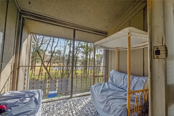 a bedroom with furniture and a window