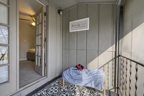 a view of a hallway with wooden floor and stairs