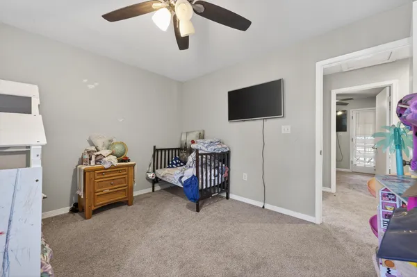 a bedroom with a bed and a television