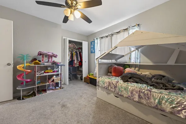 a bedroom with furniture and workout equipment
