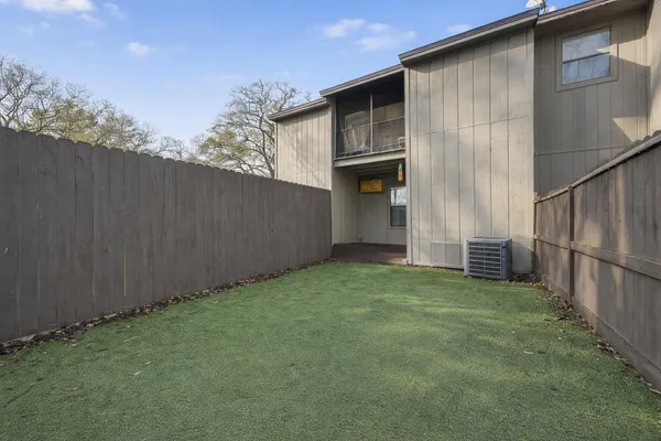 a view of backyard of house with green space