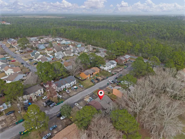 an aerial view of a house with a mountain