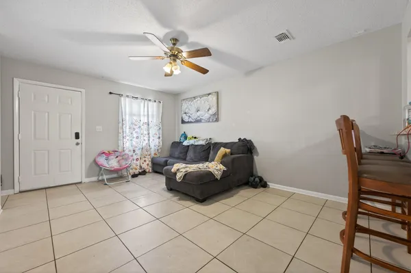 a living room with furniture and a chandelier