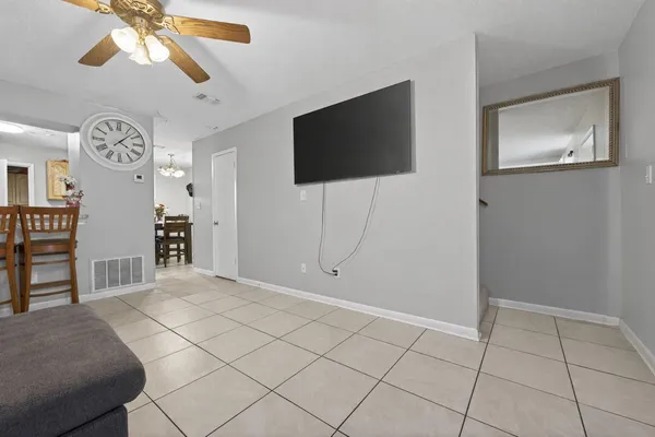 a view of a livingroom with wooden floor and a flat screen tv