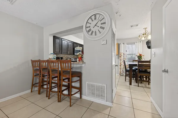 a dining room with furniture and a clock