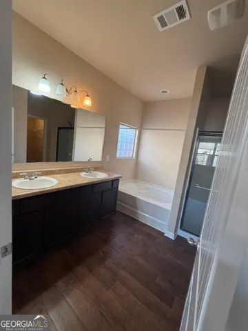 a bathroom with a double vanity sink and mirror