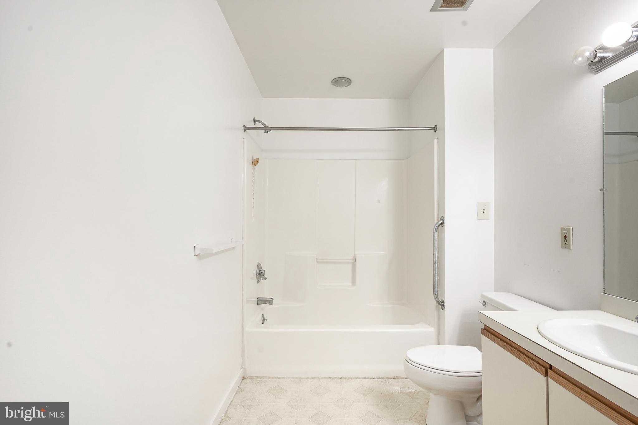 46 Brainerd Street, Unit A Mount Holly, NJ 08060 - Photo 11 of 19 a bathroom with a shower a toilet and a sink
