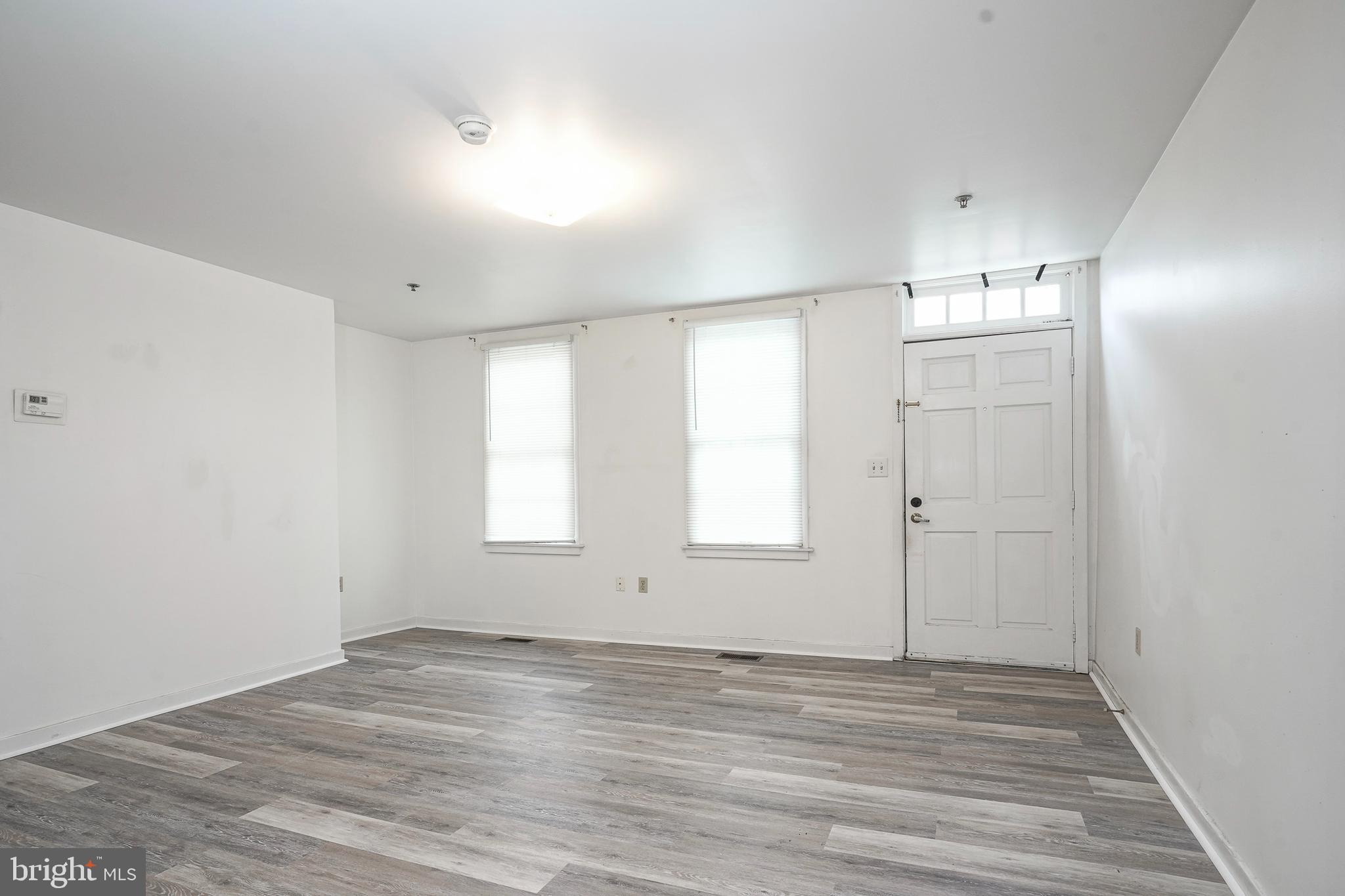 46 Brainerd Street, Unit A Mount Holly, NJ 08060 - Photo 5 of 19 an empty room with wooden floor and windows