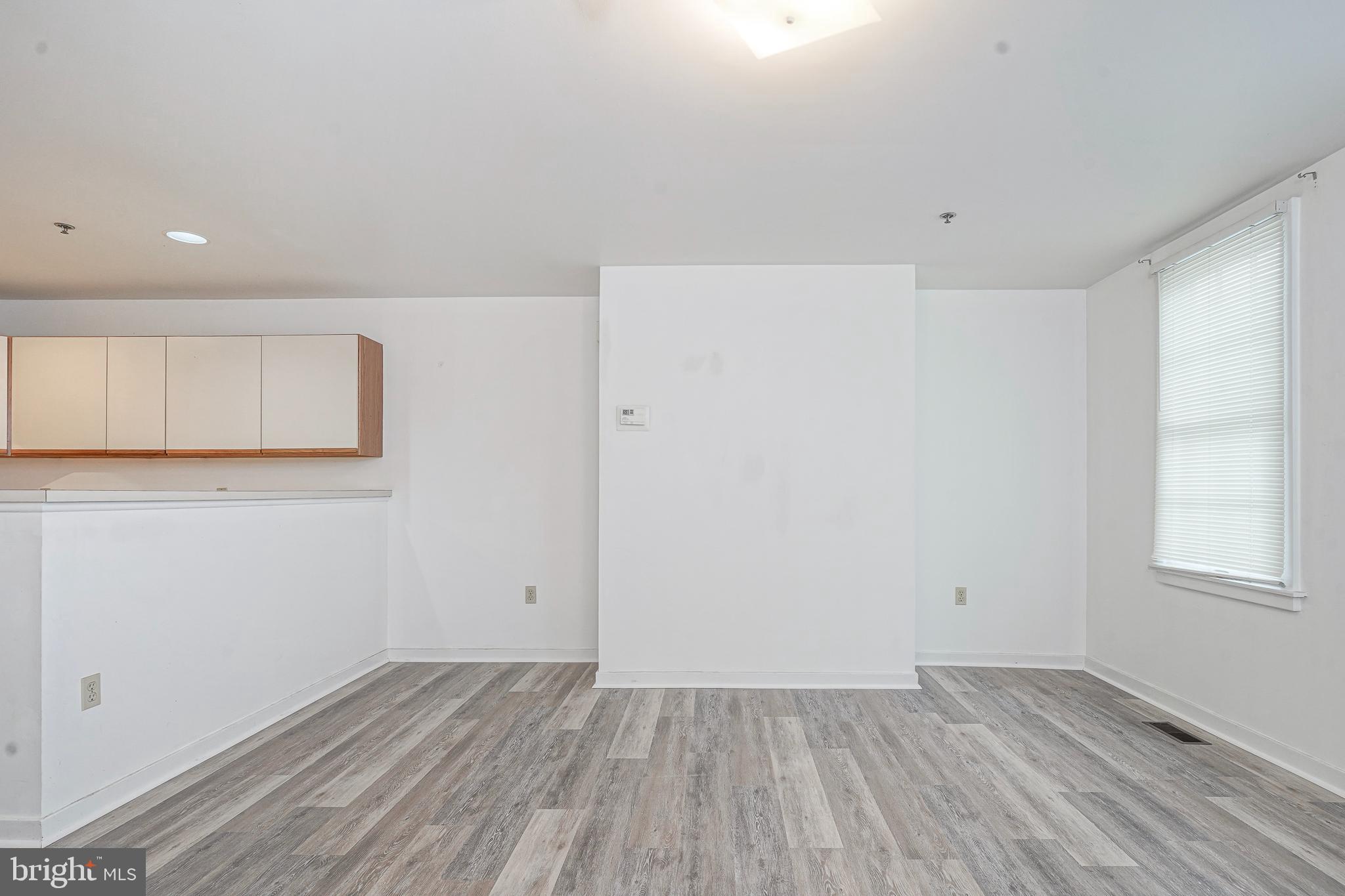 46 Brainerd Street, Unit A Mount Holly, NJ 08060 - Photo 6 of 19 an empty room with wooden floor and windows