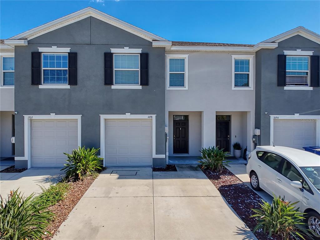 1698 Hubbell Road Wesley Chapel, FL 33543 - Photo 1 of 1 a front view of house and yard with green space