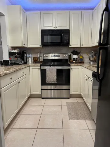 a kitchen with stainless steel appliances a stove a sink and a microwave