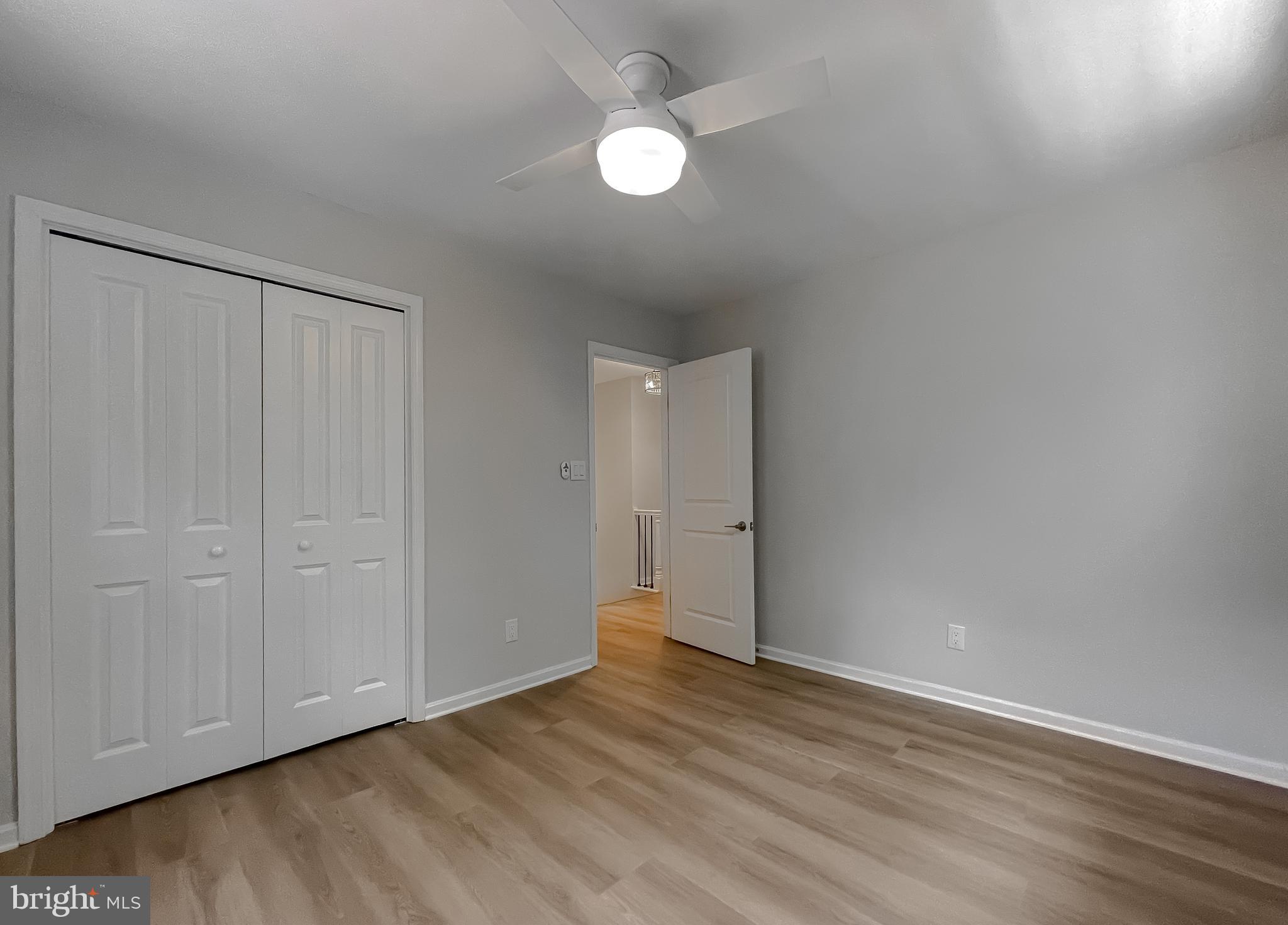 22373 Enoch Road Leonardtown, MD 20650 - Photo 53 of 74 a view of an empty room with wooden floor and a window