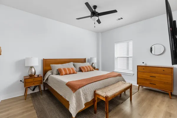 a bedroom with a bed and flat screen tv