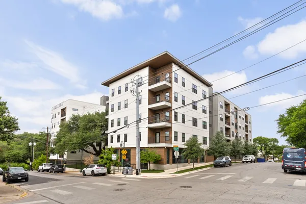 a city street with tall building and a large windows