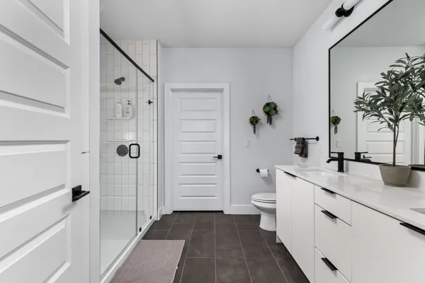 a bathroom with double vanity sink and a mirror